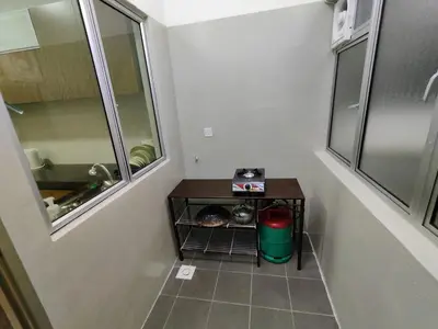 a bathroom with a small table and a window at Family Apartment at The Quintet Cameron Highlands in Cameron Highlands