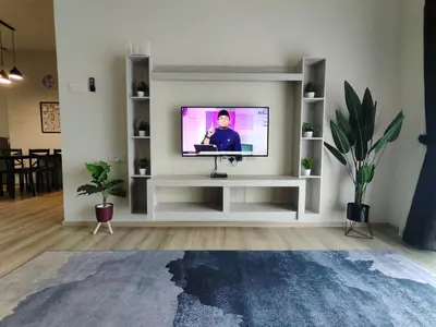 a living room with a television on a white shelf at Family Apartment at The Quintet Cameron Highlands in Cameron Highlands