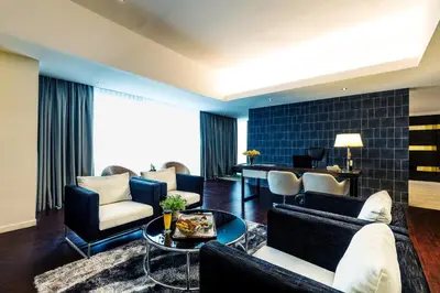 a living room with a couch and chairs and a table at Ixora Hotel Penang in Perai