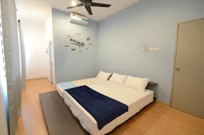 a bedroom with a bed with a clock on the wall at Decozy Homestay (14pax++) in Ipoh