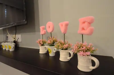 a group of pom pom cups with flowers in them at Decozy Homestay (14pax++) in Ipoh