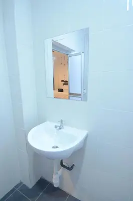 a white sink in a bathroom with a mirror at Decozy Homestay (14pax++) in Ipoh