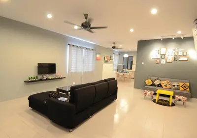 a living room with a couch and a ceiling fan at Decozy Homestay (14pax++) in Ipoh