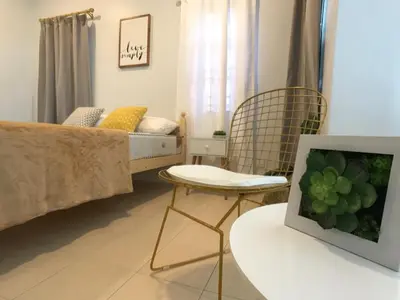 a living room with a bed and a table with a tv at beNordic -8-10mins Tambun Water Park-10-14Pax in Ipoh