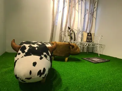 a room with a cow chair and a teddy bear at beNordic -8-10mins Tambun Water Park-10-14Pax in Ipoh