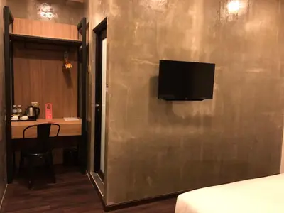 a room with a wall with a television on it at K Boutique Hotel in Teluk Intan