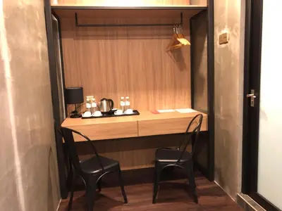 a small kitchen with two chairs and a table at K Boutique Hotel in Teluk Intan