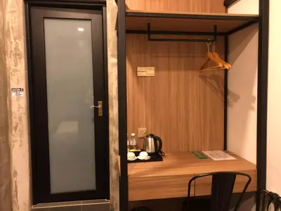 a door leading into a room with a wooden desk at K Boutique Hotel in Teluk Intan