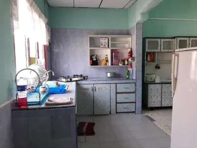 a kitchen with a sink and a counter top at Homestay Ustaz in Taiping