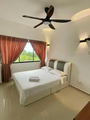 a bedroom with a bed with a ceiling fan at The Ferringhi Sea View at Sri Sayang in Batu Ferringhi