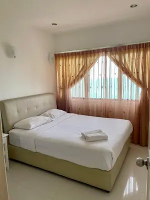 a bedroom with a large bed with a window at The Ferringhi Sea View at Sri Sayang in Batu Ferringhi