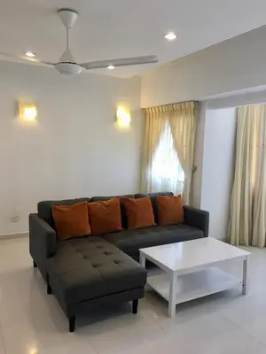 a living room with a couch and a coffee table at The Ferringhi Sea View at Sri Sayang in Batu Ferringhi
