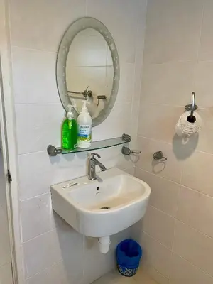 a bathroom with a sink and a mirror at The Ferringhi Sea View at Sri Sayang in Batu Ferringhi