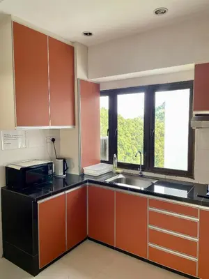 a kitchen with a sink and a microwave at The Ferringhi Sea View at Sri Sayang in Batu Ferringhi