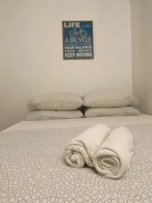 a bed with two towels on top of it at Hikers Sleep Port Guesthouse in Cameron Highlands