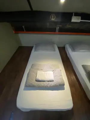 a pair of beds in a small room at Hikers Sleep Port Guesthouse in Cameron Highlands