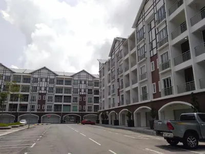 an empty street in front of a large apartment building at Golden Hill 3 Room Apt @ Night Market in Cameron Highlands