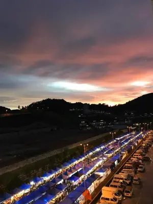 a long line of cars parked in a parking lot at night at Golden Hill 3 Room Apt @ Night Market in Cameron Highlands