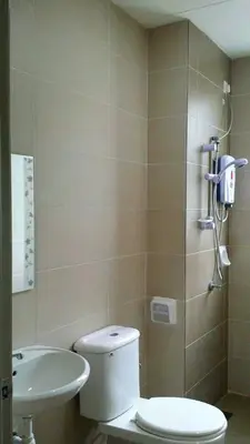 a bathroom with a toilet and a sink at Golden Hill 3 Room Apt @ Night Market in Cameron Highlands