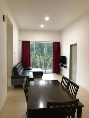 a living room with a table and a couch at Golden Hill 3 Room Apt @ Night Market in Cameron Highlands