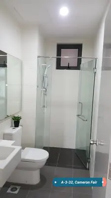 a bathroom with a toilet and a glass shower at SL TR Homstay in Cameron Highlands