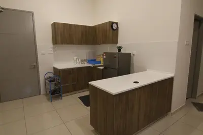 a kitchen with wooden cabinets and a refrigerator at SL TR Homstay in Cameron Highlands