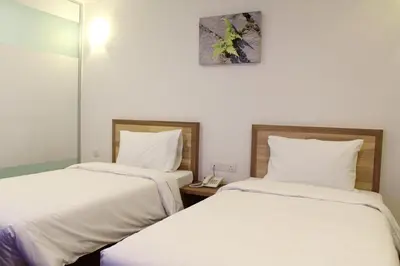 two beds sitting next to each other in a room at Greencity Hotel in Sungai Petani