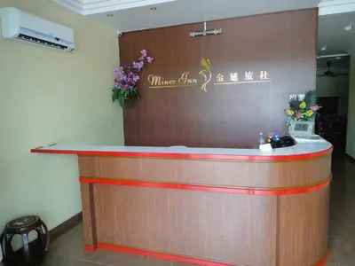 a bar in a restaurant with flowers on the wall at Mines Inn Hotel in Gua Musang
