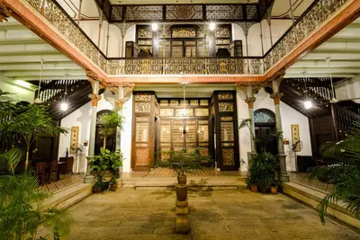 an ornate building with a lobby with plants at Cheong Fatt Tze - The Blue Mansion in George Town