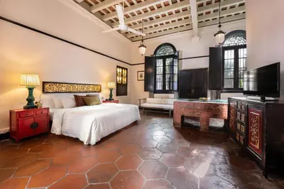 a bedroom with a bed and a flat screen tv at Cheong Fatt Tze - The Blue Mansion in George Town