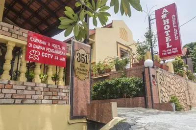 a building with signs on the side of it at Anggerik Lodging in George Town