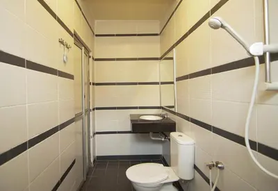 a small bathroom with a toilet and a sink at Anggerik Lodging in George Town