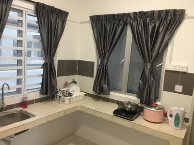 a kitchen with black curtains and a sink at Cameron Prima Apartment @ Cameron Jaya in Cameron Highlands