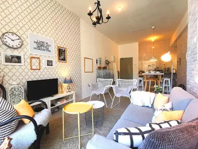 a living room with a couch and a tv at Barington Square near Night Market in Cameron Highlands
