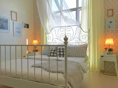 a bedroom with a white bed with a window at Barington Square near Night Market in Cameron Highlands