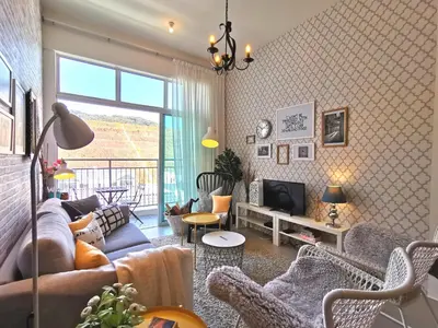 a living room with a couch and a tv at Barington Square near Night Market in Cameron Highlands