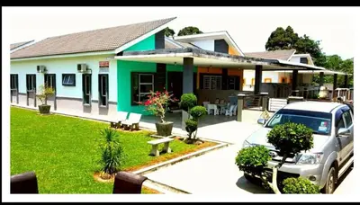 a car parked in front of a house at Taiping Homestay Husna Afina in Taiping