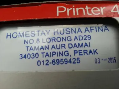a parking meter with a white label on it at Taiping Homestay Husna Afina in Taiping