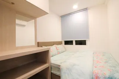 a small bedroom with a bed and a mirror at H2H - Swiss Home - Majestic Ipoh in Ipoh