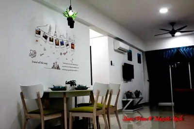 a dining room with a table and chairs at H2H - Swiss Home - Majestic Ipoh in Ipoh