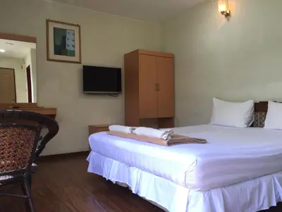 a hotel room with a bed and a tv at Hotel Sri Malim in Tanjung Malim