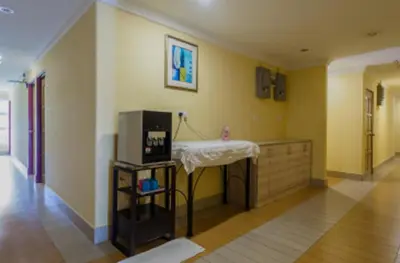 a living room with a table and a tv at Hotel Sri Malim in Tanjung Malim