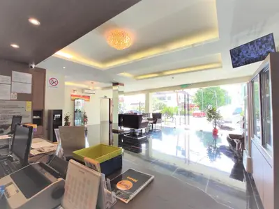 a lobby of a store with a table and chairs at Apple Suites Hotel in Sitiawan