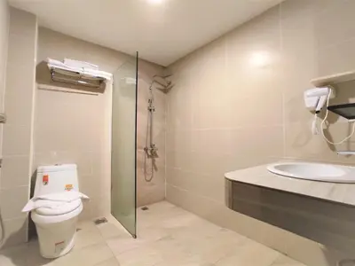 a bathroom with a toilet and a sink at Apple Suites Hotel in Sitiawan