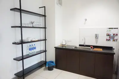 a kitchen with a counter and a sink and shelves at PM Octagon Ipoh Suites & Apartment 3 in Ipoh