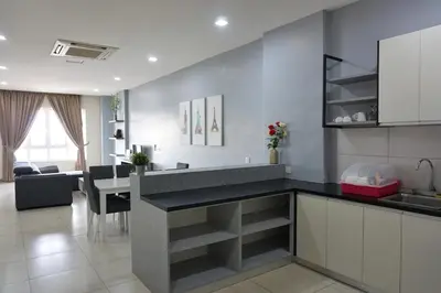 a kitchen with a counter and a living room at PM Octagon Ipoh Suites & Apartment 3 in Ipoh