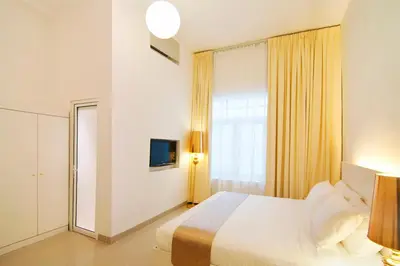 a hotel room with a bed and a window at Chulia Heritage Hotel in George Town