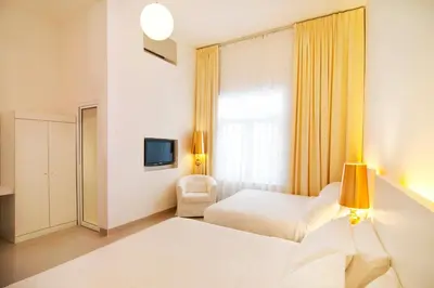 a hotel room with two beds and a window at Chulia Heritage Hotel in George Town