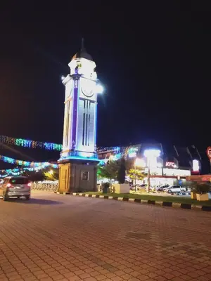 a clock tower in a city at night at Sp Central Hotel in Sungai Petani
