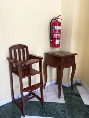a wooden chair next to a desk and a fire hydrant at Golden Hill 34 in Cameron Highlands